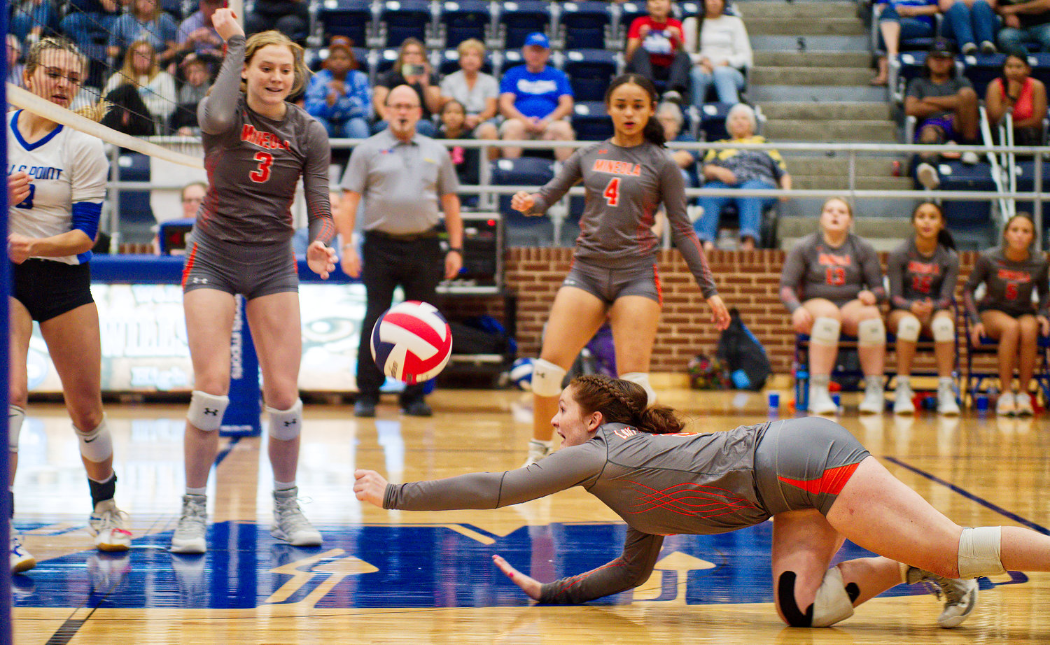 Gracie Finley reaches to save a shot for Mineola. [view more volleyball shots]